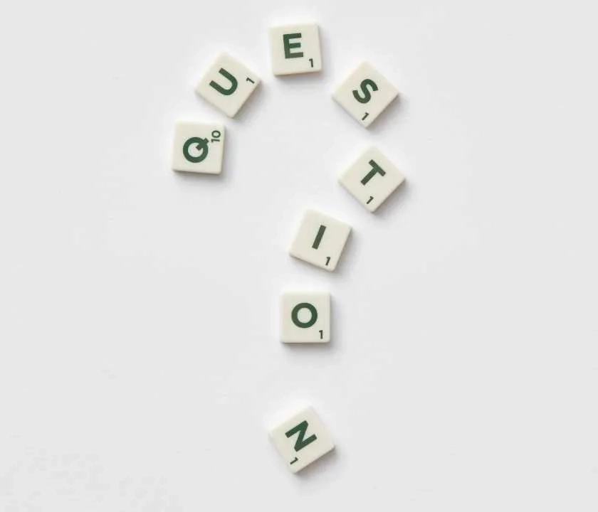 'Question' spelt out in Scrabble letters in the shape of a question mark